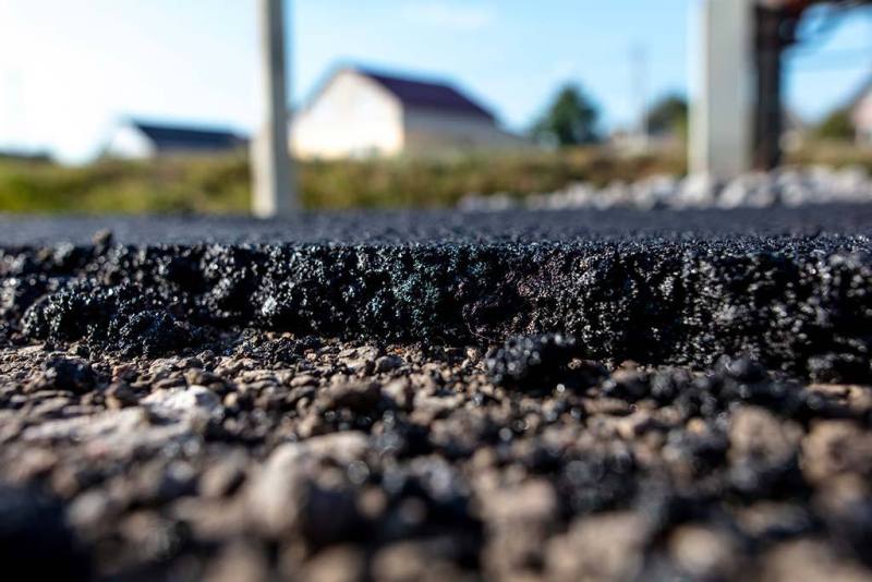 Stones on the edge of the asphalt road